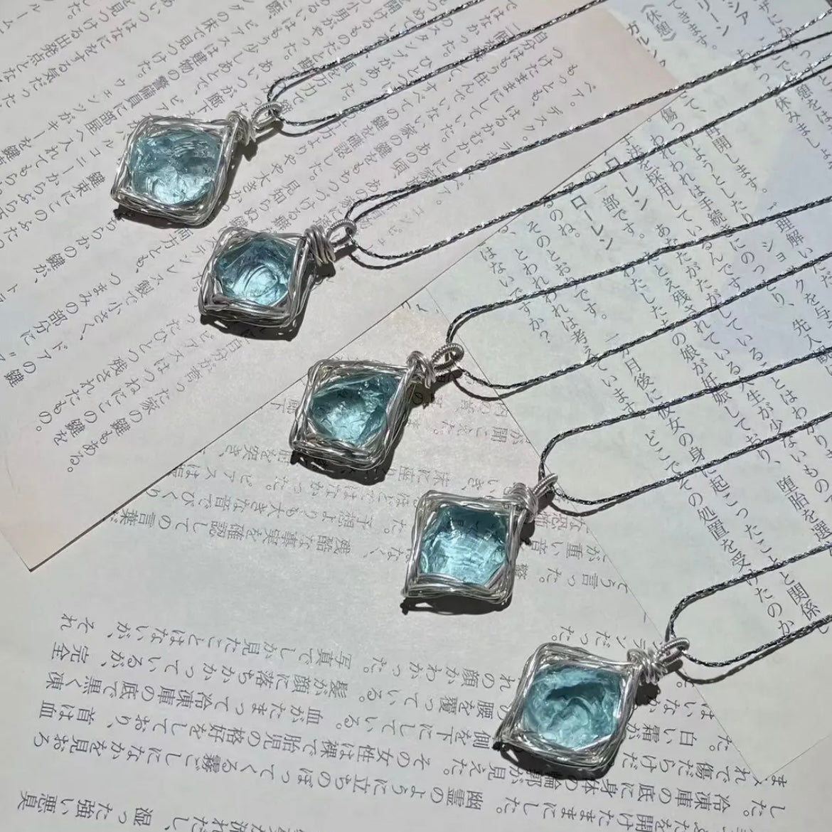 This is a handmade blue crystal heart necklace, symbolizing the heartbeat of the world.